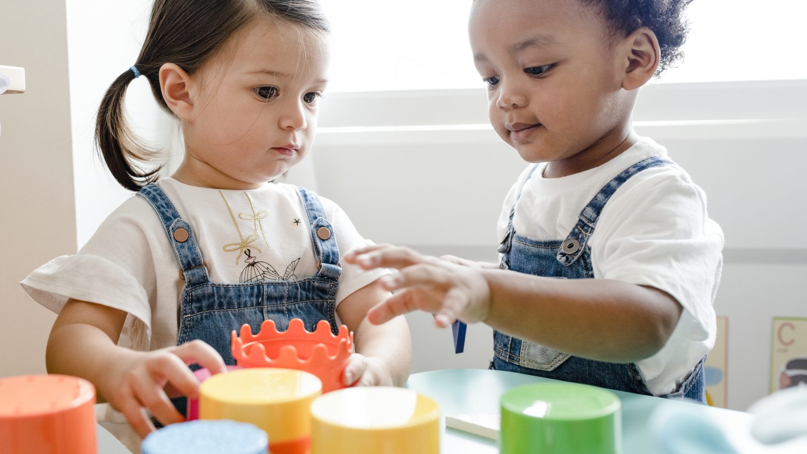 Little kids playing toys at learning center Little kids playing toys at learning center